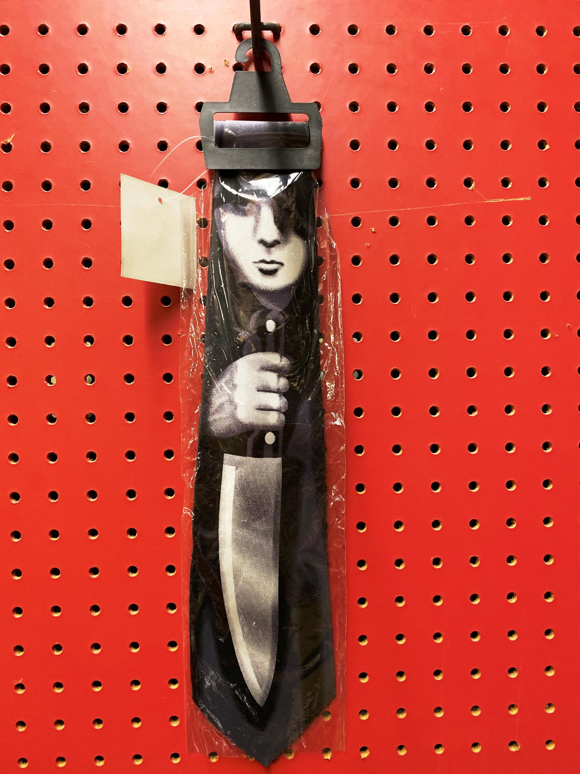 Black Necktie Girl Holding Knife Silhouette Halloween by HalloweenStore.com