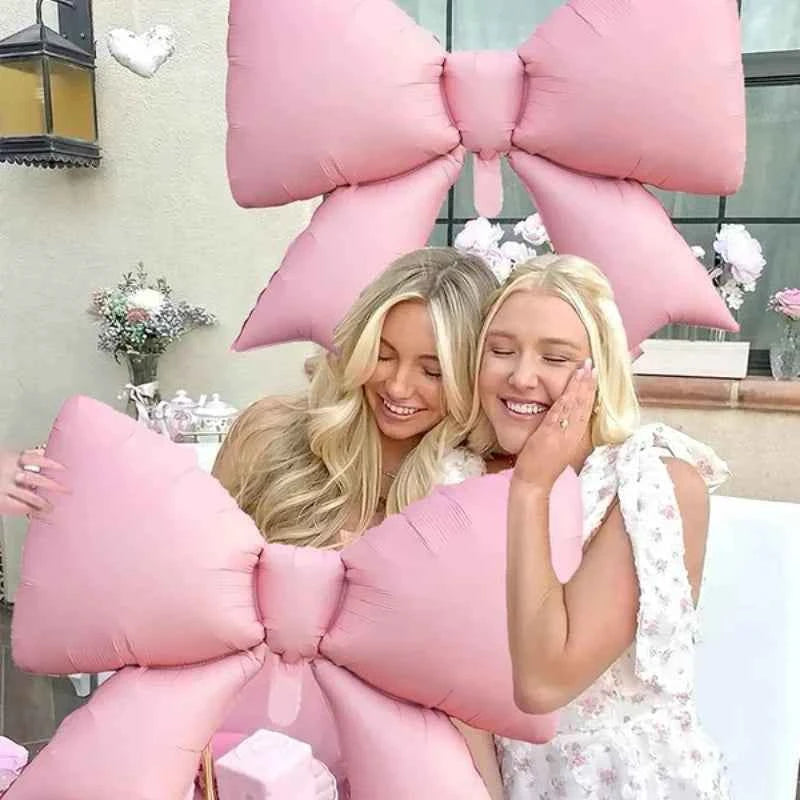 White Happy Birthday banner balloon and light pink bow balloon with pink ribbon bow, birthday party decoration