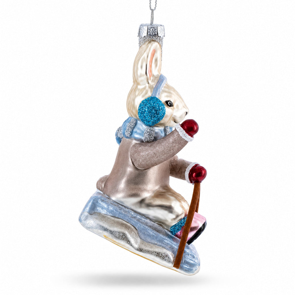 Bunny Sledding with Earmuffs Glass Christmas Ornament by BestPysanky